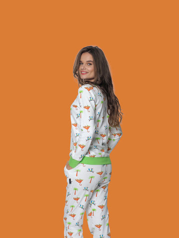 Dame lacht en kijkt over haar schouder in haar dames pyjama met shirt en pyjamabroek