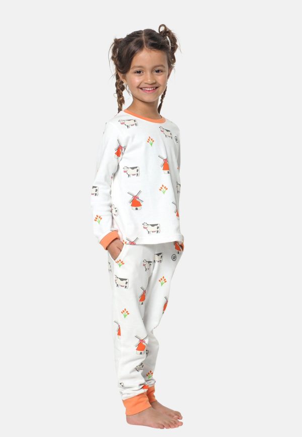 Meisje draagt een meisjes pyjama en heeft haar handen in haar broekzakken